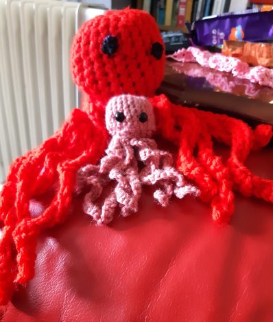 One large red Octo and one small pink Octo crocheted by MaryBrigid Turner